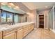 Bathroom with double sinks, vanity, tile floors, and walk in shower at 1272 Nightfire Cir, Castle Rock, CO 80104