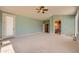 Spacious bedroom with large windows, carpet floors, and open entry to bathroom and walk-in closet at 1272 Nightfire Cir, Castle Rock, CO 80104