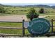 Bell Mountain Ranch Equestrian Center sign with horse riding ring and mountain views at 1272 Nightfire Cir, Castle Rock, CO 80104