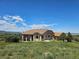 Sprawling home on a vast lot with an expansive lawn and mature trees at 1272 Nightfire Cir, Castle Rock, CO 80104