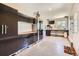 Well-organized garage with extensive cabinetry, a workbench, and epoxy flooring at 1272 Nightfire Cir, Castle Rock, CO 80104