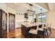 Kitchen featuring wood floors, marble countertop island, modern pendant lighting, stainless steel appliances, and white cabinets at 1272 Nightfire Cir, Castle Rock, CO 80104