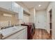 Laundry room includes a utility sink, cabinet storage, and a red front load washer and dryer at 1272 Nightfire Cir, Castle Rock, CO 80104