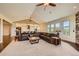 Comfortable living room boasts an open layout, large windows, a leather sectional, and stylish finishes at 1272 Nightfire Cir, Castle Rock, CO 80104