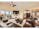 Bright living room with large windows, a built-in entertainment center, and comfortable seating for relaxation at 1272 Nightfire Cir, Castle Rock, CO 80104