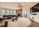 Inviting living room features a stone fireplace, plush seating, and picturesque views from multiple windows at 1272 Nightfire Cir, Castle Rock, CO 80104