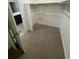 Empty walk-in closet with neutral carpet, white walls, and convenient shelving at 15646 W Floyd Dr, Morrison, CO 80465