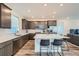 Modern kitchen with an island, stainless steel appliances, and grey cabinets at 15646 W Floyd Dr, Morrison, CO 80465