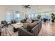 Bright living room featuring wood floors, modern lighting, and a sliding glass door at 15646 W Floyd Dr, Morrison, CO 80465