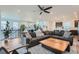 Spacious living room featuring a large sectional sofa, modern ceiling fan, and open floor plan at 15646 W Floyd Dr, Morrison, CO 80465