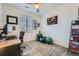 Well-lit home office featuring a sleek desk, exercise equipment, and a comfortable chair at 15646 W Floyd Dr, Morrison, CO 80465