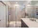 Bathroom featuring a tiled shower, a vanity with a sink, and a glass shower door at 15646 W Floyd Dr, Morrison, CO 80465