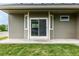Back of house with green grass, patio and sliding glass doors at 268 Naples St, Firestone, CO 80520