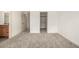 Large bedroom featuring carpet floors, neutral paint, and walk in closet at 268 Naples St, Firestone, CO 80520