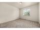 This bedroom is spacious and bright with carpet floors and a large window at 268 Naples St, Firestone, CO 80520