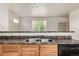 The kitchen features sleek countertops, a double stainless sink, and access to a large living area at 268 Naples St, Firestone, CO 80520