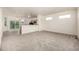 Bright, open-concept living space with new carpet flooring and recessed lighting at 268 Naples St, Firestone, CO 80520