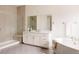 Bright bathroom with double vanity, walk-in shower, and soaking tub at 6608 S White Crow Ct, Aurora, CO 80016