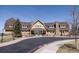 Beautiful two-story clubhouse with stone chimney and meticulously kept landscaping at 6608 S White Crow Ct, Aurora, CO 80016