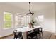 Dining room with modern decor, large windows showcasing outdoor views, and a stylish rug at 6608 S White Crow Ct, Aurora, CO 80016