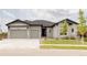 Charming single Gathering home showcasing a well-manicured lawn, stone accents, and a three-car garage at 6608 S White Crow Ct, Aurora, CO 80016