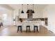 Modern kitchen with island seating, stainless steel appliances, and ample cabinet space at 6608 S White Crow Ct, Aurora, CO 80016