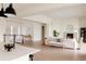 Bright, open-concept living room with a fireplace and seamlessly connected to the kitchen at 6608 S White Crow Ct, Aurora, CO 80016