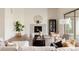 Cozy living room featuring a fireplace, modern furnishings, and abundant natural light at 6608 S White Crow Ct, Aurora, CO 80016