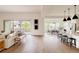 Open-concept living area showcases modern design with seamless flow to the dining and kitchen areas at 6608 S White Crow Ct, Aurora, CO 80016