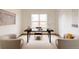 Stylish home office with modern desk, chairs, and a large window providing natural light at 6608 S White Crow Ct, Aurora, CO 80016