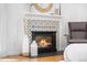 Stylish bedroom featuring a fireplace, decorative tile, and hardwood floors at 160 Bristlecone Way, Boulder, CO 80304