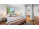 Cozy bedroom with wood floors features a large window with picturesque views at 160 Bristlecone Way, Boulder, CO 80304