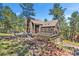 Charming exterior with a multi-level deck, beautiful brick walkway, and attached garage at 160 Bristlecone Way, Boulder, CO 80304