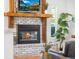 Cozy living room featuring a fireplace with a wooden mantel, a TV, and comfortable seating at 160 Bristlecone Way, Boulder, CO 80304