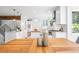 Bright, open kitchen featuring white cabinets, a center island, modern lighting, and hardwood floors at 160 Bristlecone Way, Boulder, CO 80304
