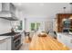 Spacious open kitchen with a butcher block island, stainless steel appliances, and adjacent dining area at 160 Bristlecone Way, Boulder, CO 80304