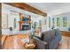 Comfortable living room featuring a brick fireplace, hardwood floors, and an abundance of natural light at 160 Bristlecone Way, Boulder, CO 80304