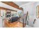 Open living room with a brick fireplace, hardwood floors, a staircase, and natural light at 160 Bristlecone Way, Boulder, CO 80304