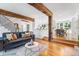 Bright, open-concept living area featuring hardwood floors and exposed wood beams, open to dining and kitchen spaces at 160 Bristlecone Way, Boulder, CO 80304