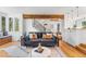 Inviting living room featuring a comfortable sofa, hardwood floors, an open staircase, and access to the kitchen at 160 Bristlecone Way, Boulder, CO 80304