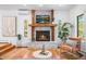 Inviting living room featuring a cozy fireplace, hardwood floors, and large windows at 160 Bristlecone Way, Boulder, CO 80304