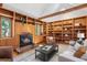 Charming living room featuring built-in wood shelving, a fireplace, and comfortable seating at 160 Bristlecone Way, Boulder, CO 80304