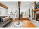 Spacious living room with hardwood floors, fireplace, and open floor plan leading into the modern kitchen at 160 Bristlecone Way, Boulder, CO 80304