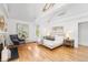 Sunlit primary bedroom boasts vaulted ceilings, skylight, wood floors, and modern decor at 160 Bristlecone Way, Boulder, CO 80304