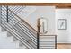 Modern staircase featuring sleek black railings and light, neutral-toned steps and walls at 160 Bristlecone Way, Boulder, CO 80304