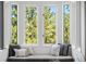 Inviting window seat nook with comfortable cushions and pillows offering scenic views of the surrounding trees at 160 Bristlecone Way, Boulder, CO 80304