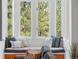 Comfortable window seat featuring cushions and pillows, with a view of the surrounding trees at 160 Bristlecone Way, Boulder, CO 80304