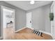 Bright bedroom with hardwood floors, neutral walls, and an adjacent room visible through an open doorway at 215 E 11Th Ave # D8, Denver, CO 80203
