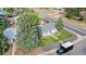 Aerial view of home with manicured lawn, fenced yard, and mature trees in quiet neighborhood at 103 S Zenobia St, Denver, CO 80219