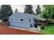 Rear exterior of the home showcasing the siding, windows, covered patio, and fenced backyard at 103 S Zenobia St, Denver, CO 80219